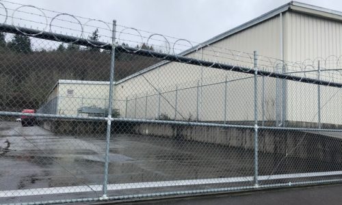 Back of Warehouse View through Fence