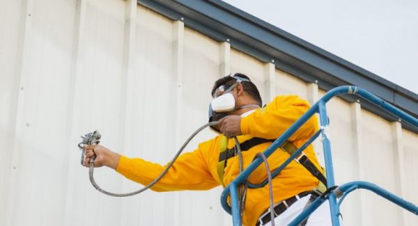 commercial painter painting an office building