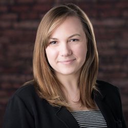 A headshot of Katy Shackelford in professional attire.